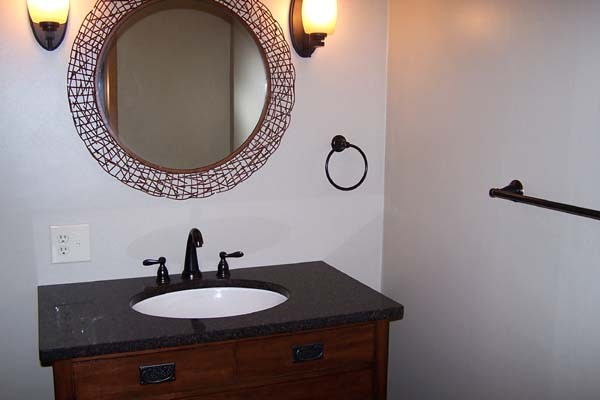 vanity with copper and round framed mirror