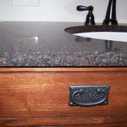 copper flecked granite counter on vanity