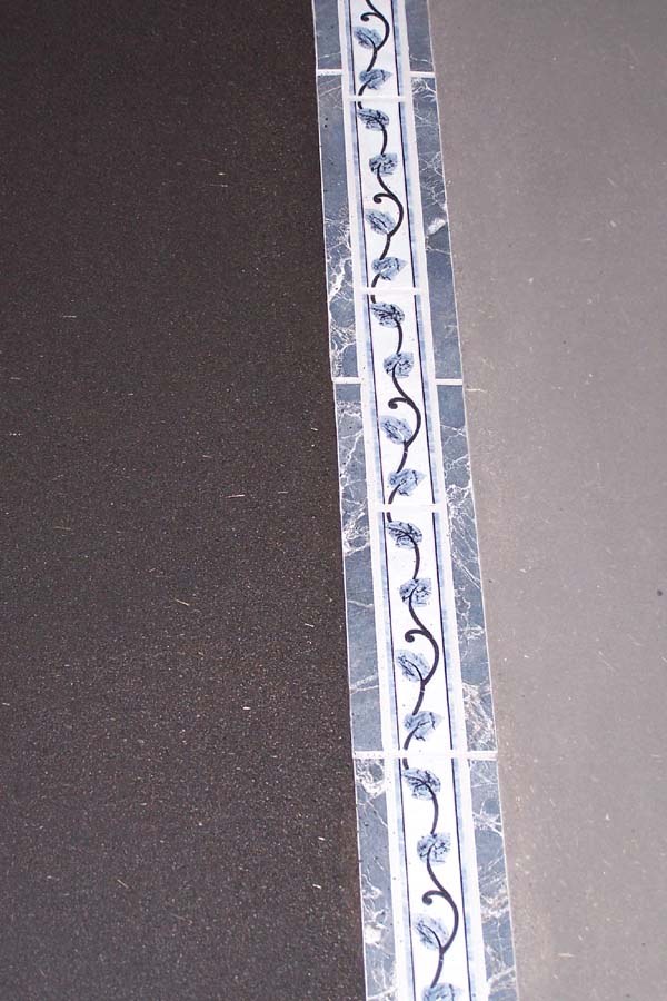 close up tile inlay into earthen floor
