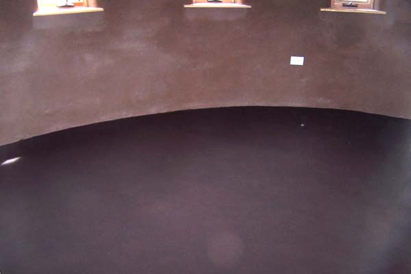 earthen plaster and curved studio wall