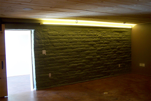 rustic adobe wall feature in man cave