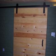 barn door leading from man cave to exercise room